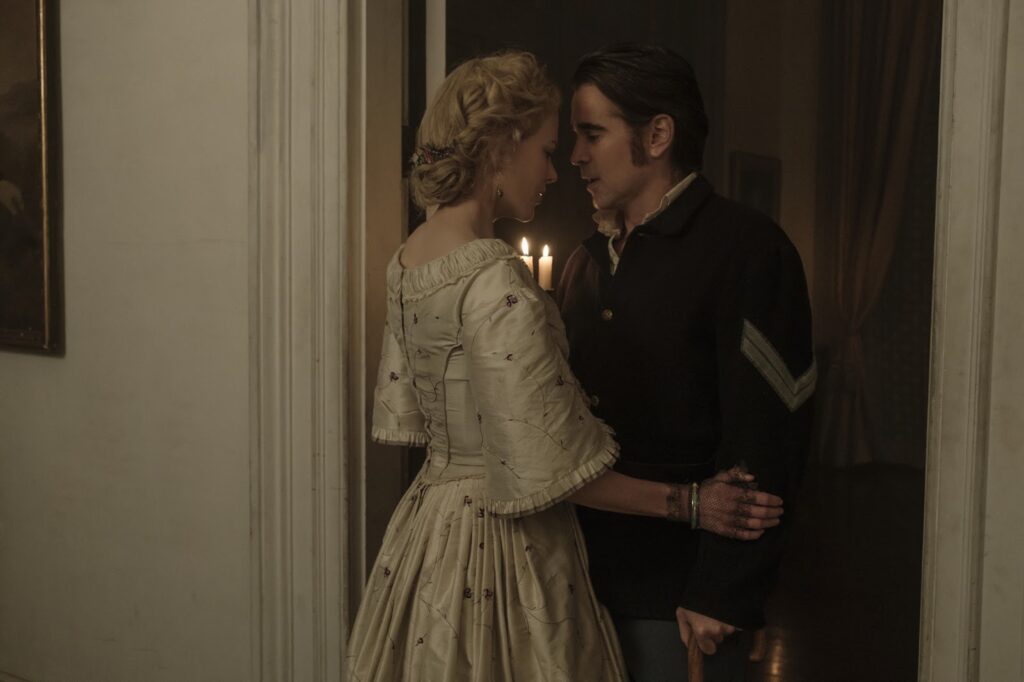 A man and a woman in period clothing having an intimate moment by candlelight