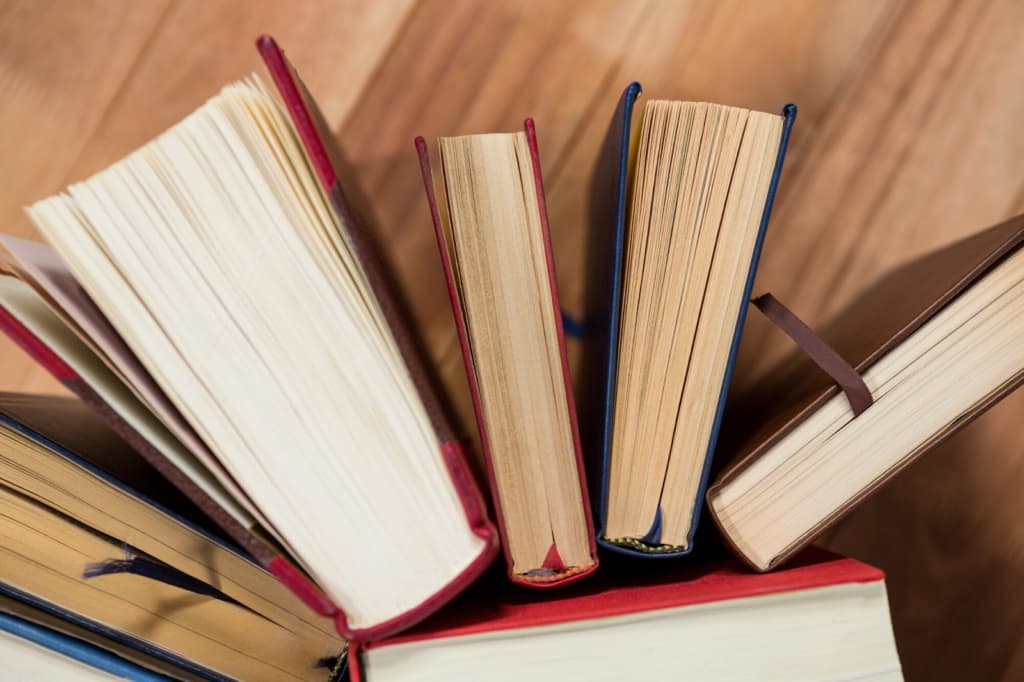 Various books arranged on a table