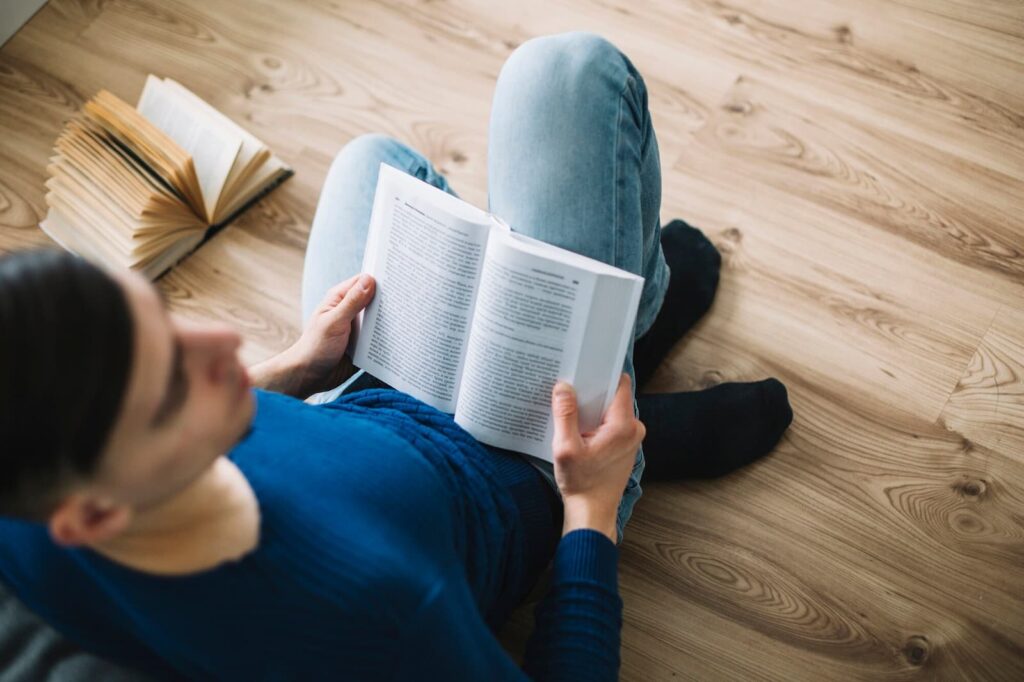 Man reading near sofa